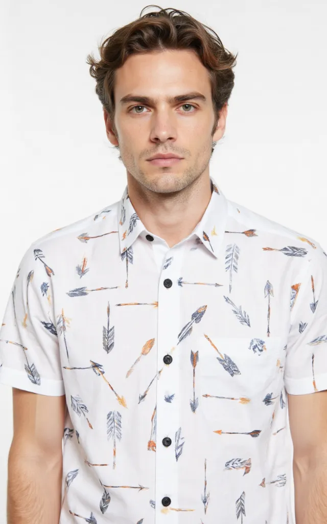 A French model wearing an Arrow pattern   printed shirt, against a white background, in a front   facing bust portrait